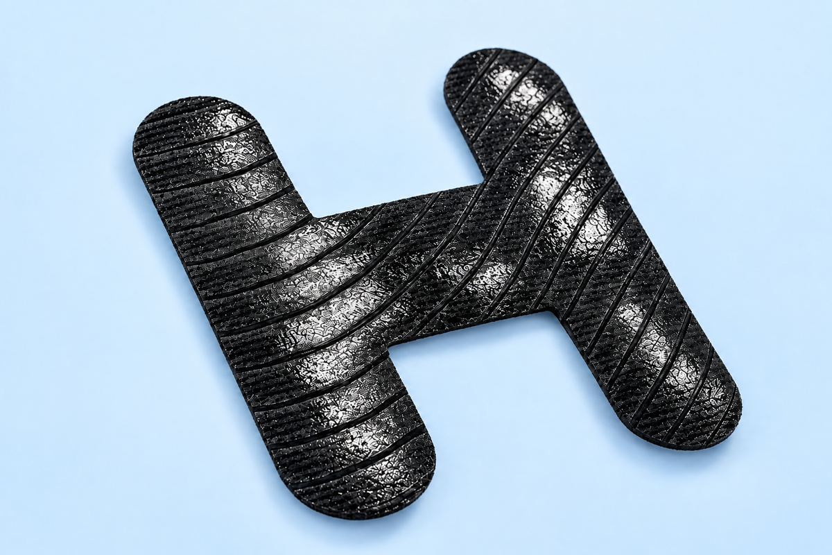 Illustration of fingertips holding a curved black nonwoven strip.